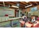 Utility basement with worktables and storage, illuminated by fluorescent lights and featuring pegboard walls at 3498 Overland Trl, Ellenwood, GA 30294