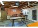 Spacious basement ideal for workshop or storage, featuring workbenches, lighting, and pegboard walls at 3498 Overland Trl, Ellenwood, GA 30294