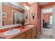 Bathroom featuring a double vanity and a large framed mirror, illuminated by overhead lighting at 3498 Overland Trl, Ellenwood, GA 30294