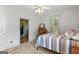 Bedroom featuring a metal bed frame, neutral walls, and a view of an adjacent room at 3498 Overland Trl, Ellenwood, GA 30294