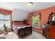 Comfortable bedroom featuring neutral carpet and a traditional wood bed frame at 3498 Overland Trl, Ellenwood, GA 30294