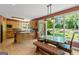 Bright dining area with hardwood floors, large windows offering scenic backyard views at 3498 Overland Trl, Ellenwood, GA 30294