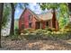Beautiful two-story home with red siding, stone accents, and a well-maintained front yard with mature trees at 3498 Overland Trl, Ellenwood, GA 30294