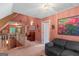 Spacious hallway showcasing natural light, comfortable seating, and views to rooms beyond at 3498 Overland Trl, Ellenwood, GA 30294