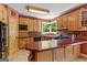 Charming kitchen features wood cabinets, countertops, and a large window overlooking the backyard at 3498 Overland Trl, Ellenwood, GA 30294