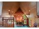 Vaulted living room with wood ceilings, a stone fireplace, and natural light pouring through the windows at 3498 Overland Trl, Ellenwood, GA 30294
