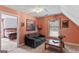 Cozy sitting room with a plush sofa, warm color palette, and access to an adjacent bedroom at 3498 Overland Trl, Ellenwood, GA 30294