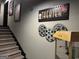 Finished basement with stairs and theater decor including a popcorn machine at 2643 Edgewater Ct, Jonesboro, GA 30236