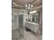Spacious bathroom showcasing a large glass shower, dual sinks, and modern finishes at 2643 Edgewater Ct, Jonesboro, GA 30236