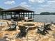 Outdoor fire pit area with Adirondack chairs overlooking the lake at 2643 Edgewater Ct, Jonesboro, GA 30236