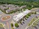 Stunning aerial view of a neighborhood featuring townhomes near commercial buildings with ample parking and roundabout at 1094 Township Sq, Alpharetta, GA 30022