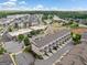 Aerial view of a community featuring townhomes, commercial areas, and lush greenery at 1094 Township Sq, Alpharetta, GA 30022