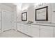 Bright bathroom with dual vanities, granite countertops, framed mirrors, and modern lighting at 1094 Township Sq, Alpharetta, GA 30022
