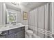 Bathroom with vanity, toilet, and shower/tub combo with decorative curtain at 1094 Township Sq, Alpharetta, GA 30022