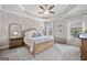 Spacious bedroom showcasing a trey ceiling, a ceiling fan, and natural light from two windows at 1094 Township Sq, Alpharetta, GA 30022