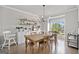 Elegant dining room with a large wooden table, hardwood floors, and a stylish chandelier fixture at 1094 Township Sq, Alpharetta, GA 30022
