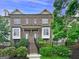 Charming exterior view of a brick townhome featuring a well-manicured front yard and inviting entrance at 1094 Township Sq, Alpharetta, GA 30022