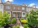 Beautiful brick townhome with well-maintained landscaping, inviting entrance, and neutral colors at 1094 Township Sq, Alpharetta, GA 30022