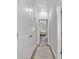 Hallway view leading to a bedroom featuring hardwood floors and neutral walls at 1094 Township Sq, Alpharetta, GA 30022