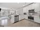 Modern kitchen featuring white cabinets, stainless steel appliances, and granite countertops at 1094 Township Sq, Alpharetta, GA 30022
