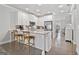 Bright kitchen features white cabinetry, a large island with seating, and stainless steel appliances at 1094 Township Sq, Alpharetta, GA 30022