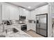 Modern kitchen with stainless steel appliances, white cabinets, and elegant granite countertops at 1094 Township Sq, Alpharetta, GA 30022