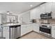 Updated kitchen featuring stainless steel appliances, modern cabinets, and granite countertops at 1094 Township Sq, Alpharetta, GA 30022