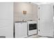 Laundry room with front-loading washer and dryer units and a wire shelf at 1094 Township Sq, Alpharetta, GA 30022