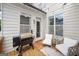 Cozy covered patio features a grill and comfortable seating, perfect for outdoor enjoyment at 1094 Township Sq, Alpharetta, GA 30022