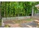 A lush, green backyard with mature trees and a wooden picket fence at 136 Glynn Addy Dr, Stockbridge, GA 30281