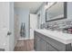 Stylish bathroom featuring modern vanity, gray mosaic tile, and wood-look flooring at 136 Glynn Addy Dr, Stockbridge, GA 30281