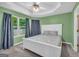 Comfortable bedroom with plush carpet, a bright window, and soothing green walls at 136 Glynn Addy Dr, Stockbridge, GA 30281