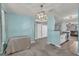 Open dining space featuring a stylish light fixture, seamless transition to the kitchen, and light blue walls at 136 Glynn Addy Dr, Stockbridge, GA 30281
