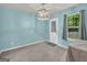 Inviting room featuring soft blue walls, plush carpet, and a door leading to outdoor spaces at 136 Glynn Addy Dr, Stockbridge, GA 30281