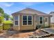 Back of home featuring an exterior door, windows and a stone lined garden at 136 Glynn Addy Dr, Stockbridge, GA 30281