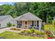 Single-story home features a cozy porch with rocking chairs and a landscaped front yard at 136 Glynn Addy Dr, Stockbridge, GA 30281