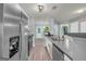 Modern kitchen featuring stainless steel appliances, laminate flooring, and views into other rooms at 136 Glynn Addy Dr, Stockbridge, GA 30281