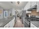 Bright kitchen with white cabinetry, stainless steel appliances and hardwood flooring extending to the living space at 136 Glynn Addy Dr, Stockbridge, GA 30281
