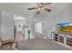 Inviting living room featuring a TV, a ceiling fan, and a seamless flow into the kitchen at 136 Glynn Addy Dr, Stockbridge, GA 30281