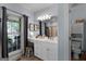 Bathroom with an expansive vanity with seated makeup area, and large window at 1561 Aiken Chafin Ln, Mcdonough, GA 30252