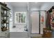 Light-filled bathroom with soaking tub, shower, and large window with nature views at 1561 Aiken Chafin Ln, Mcdonough, GA 30252