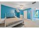 Bright bedroom with a white metal bedframe, sleek ceiling fan, and ample natural light at 1561 Aiken Chafin Ln, Mcdonough, GA 30252