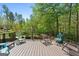 Deck features outdoor seating and wooded views at 1561 Aiken Chafin Ln, Mcdonough, GA 30252
