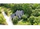 Charming home with a well-maintained lawn and lush landscaping, complemented by a long driveway at 1561 Aiken Chafin Ln, Mcdonough, GA 30252