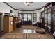 Spacious home office with built-in wooden desk, cabinets, bookshelves, and a bay window at 1561 Aiken Chafin Ln, Mcdonough, GA 30252