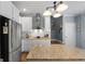 Well-appointed kitchen featuring granite island, stainless steel appliances, and ample natural light at 1561 Aiken Chafin Ln, Mcdonough, GA 30252