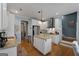 Modern kitchen with granite countertops, white cabinetry, stainless steel appliances, and hardwood floors at 1561 Aiken Chafin Ln, Mcdonough, GA 30252