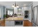 A spacious kitchen with an island, stainless steel appliances, and white cabinetry at 1561 Aiken Chafin Ln, Mcdonough, GA 30252