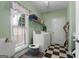 Well-lit laundry room features a washer, dryer, and practical shelving and window at 1561 Aiken Chafin Ln, Mcdonough, GA 30252
