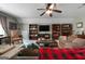 Cozy living room showcasing comfortable sofas, a ceiling fan, and built-in shelving at 1561 Aiken Chafin Ln, Mcdonough, GA 30252